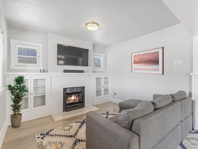 Living area featuring a central fireplace with an ornate black grate and a light-toned hearth