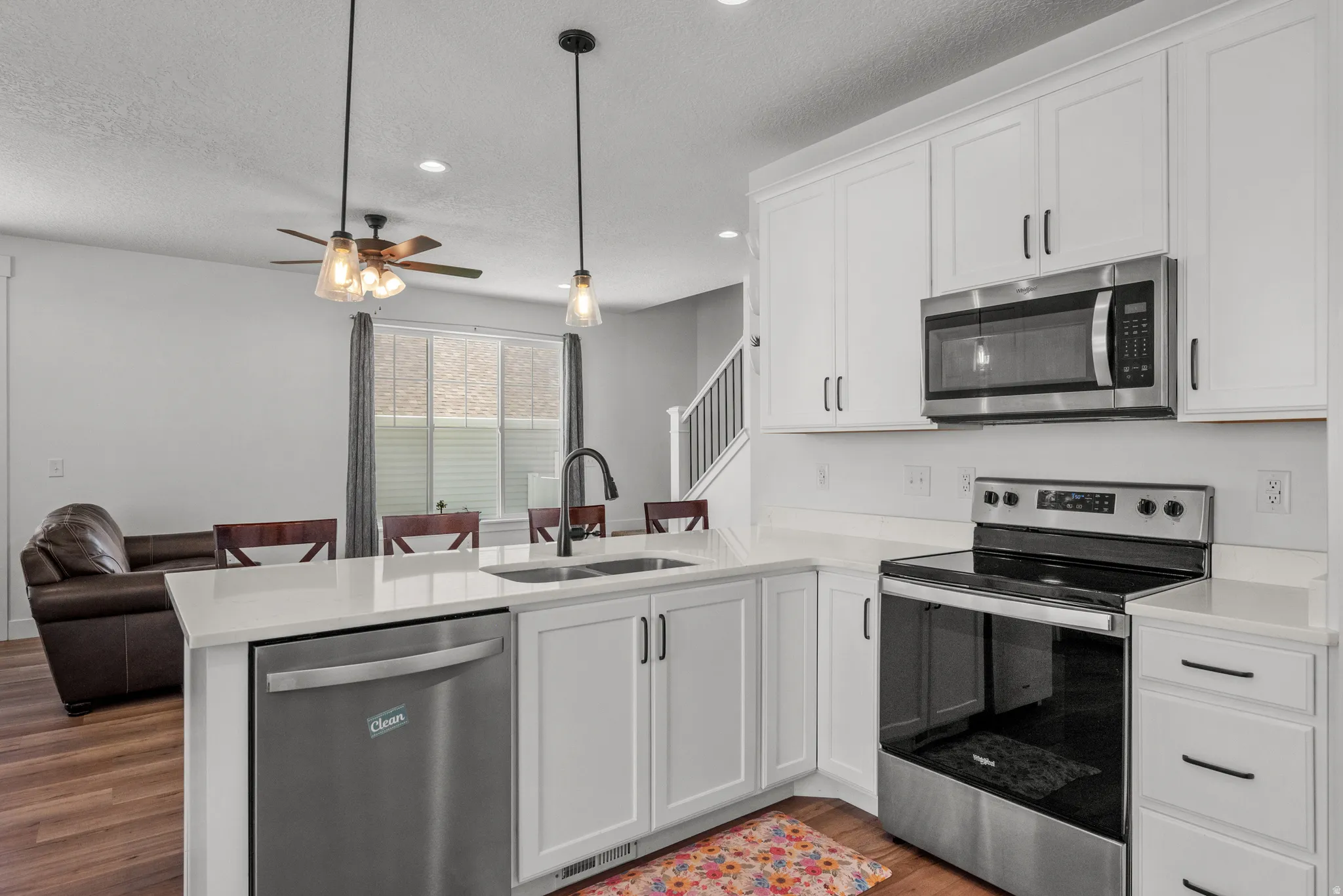 Modern kitchen featuring white cabinetry and stainless steel appliances
