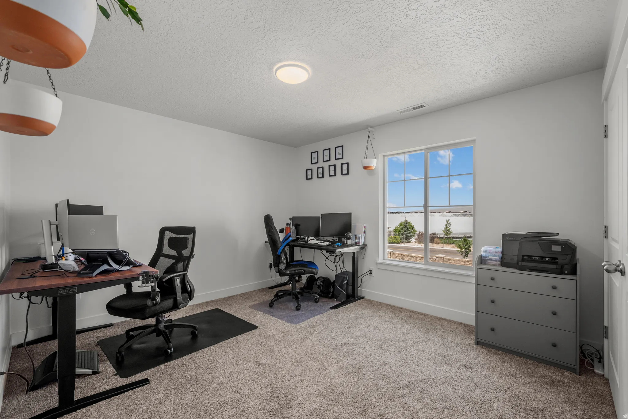 Room featuring light gray carpet, white walls, and a large window with white trim