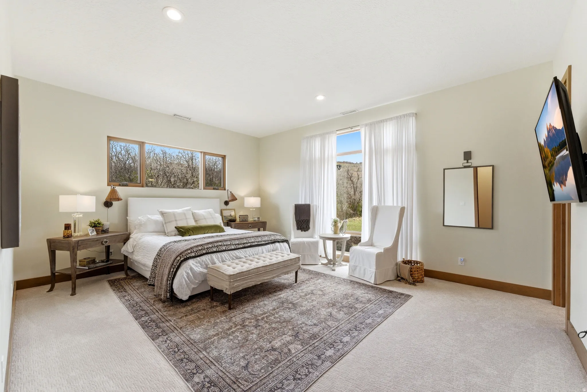 Spacious room featuring light-colored walls and soft carpet