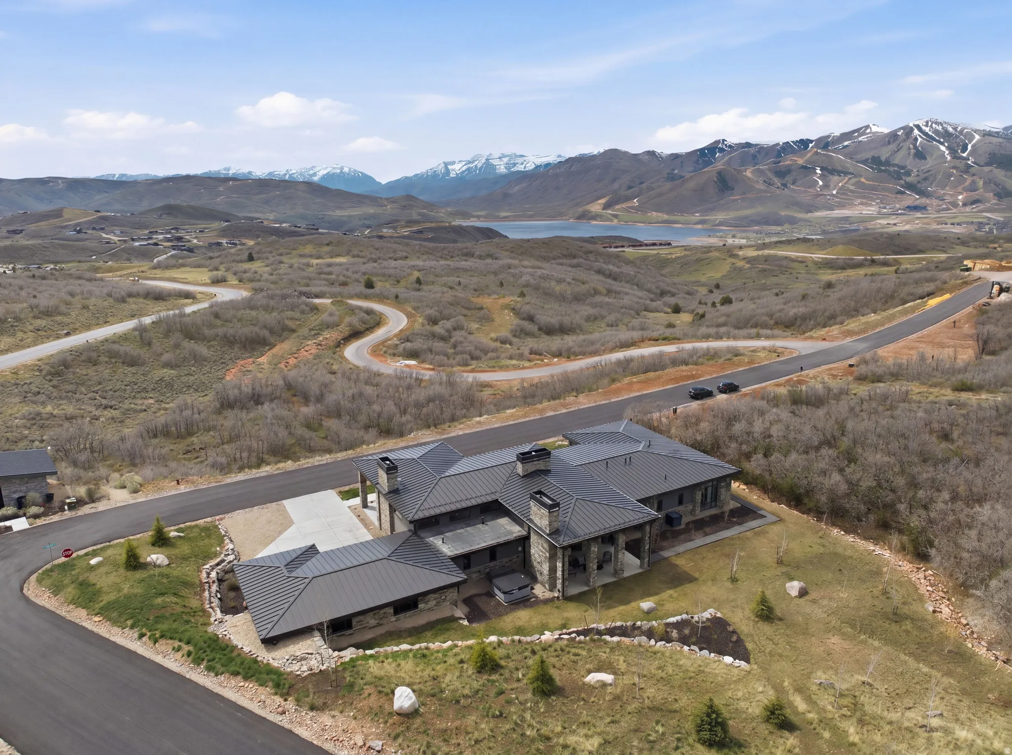 Expansive property featuring a stone and siding exterior with a dark metal roof