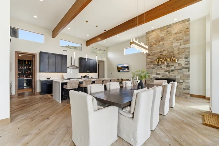 Open-concept living space with wood-finish flooring and exposed ceiling beams
