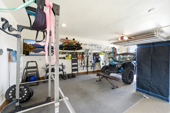 Garage space featuring textured flooring and a ceiling fan