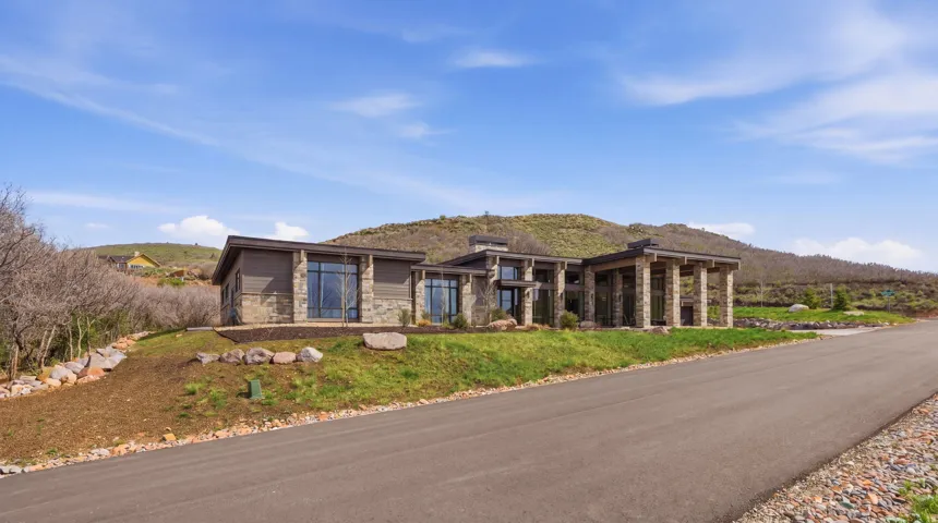 Contemporary-style residence featuring stone and siding exterior accents