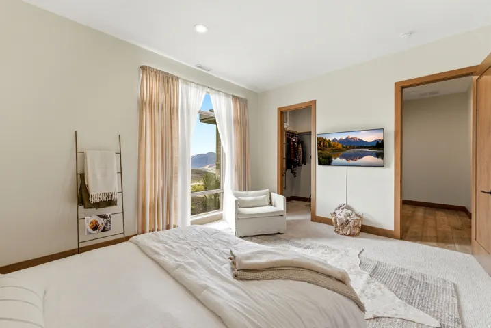 Room featuring a large window with mountain scenery, recessed lighting, and a wall-mounted display