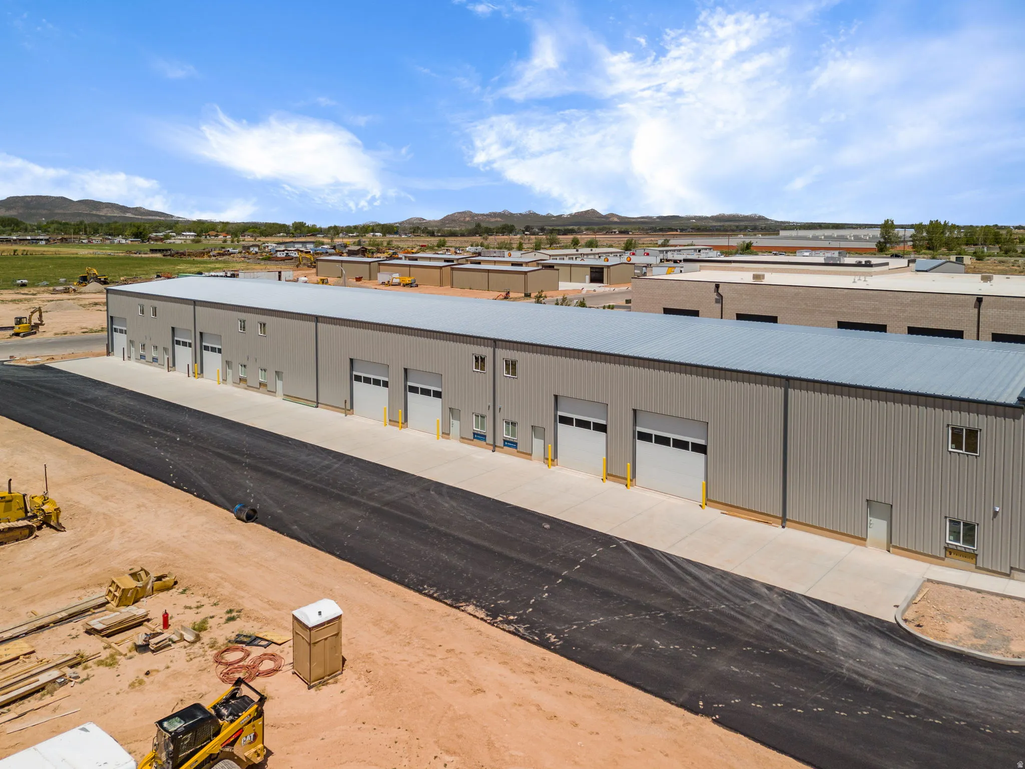 Industrial facility featuring a metal exterior and multiple overhead doors