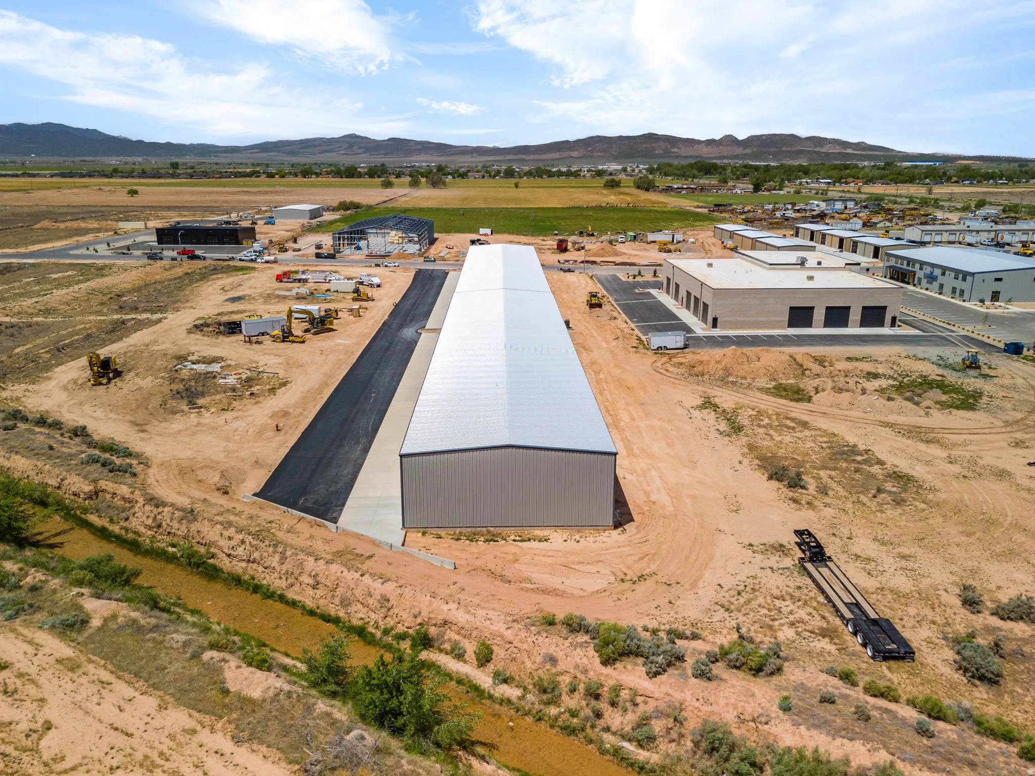 Large commercial building featuring a metal roof and panel siding