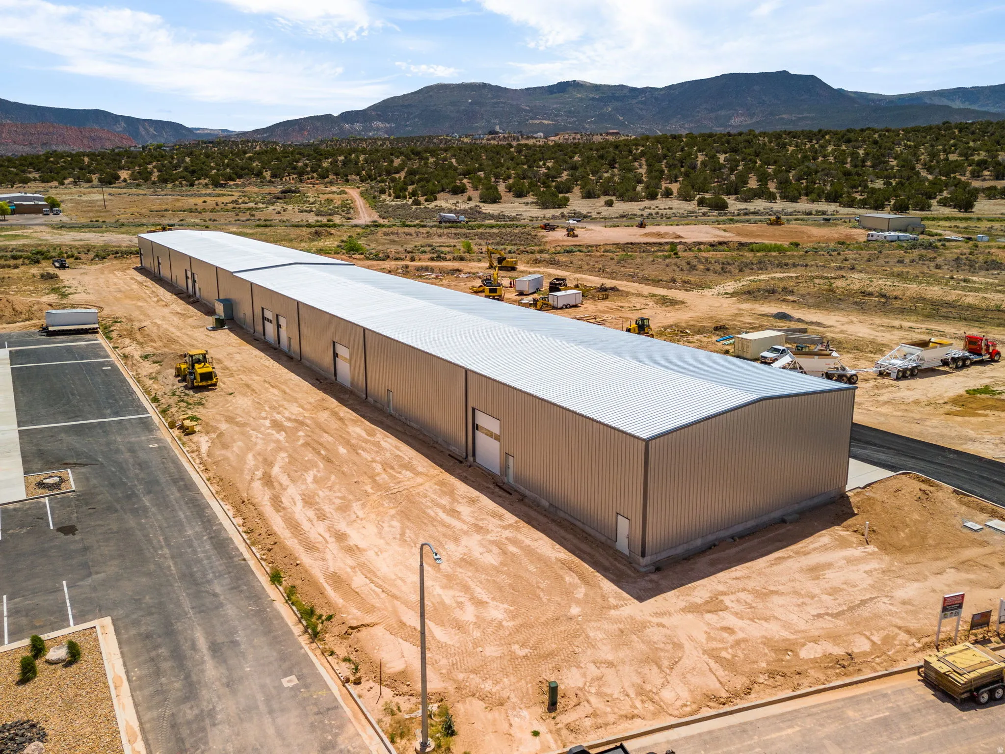 Expansive industrial building featuring multiple access points and a metal roof