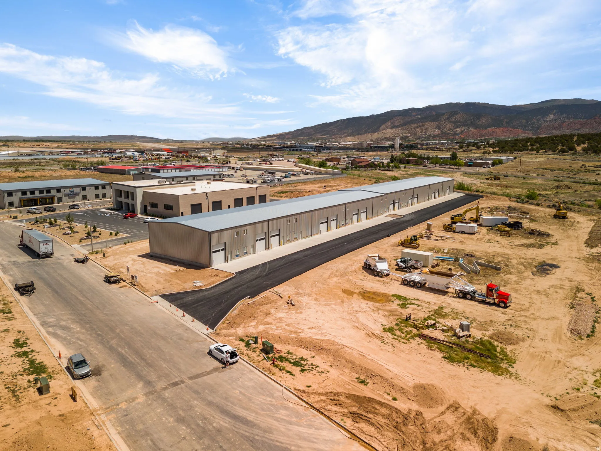 Industrial building featuring multiple bay doors and a paved loading dock