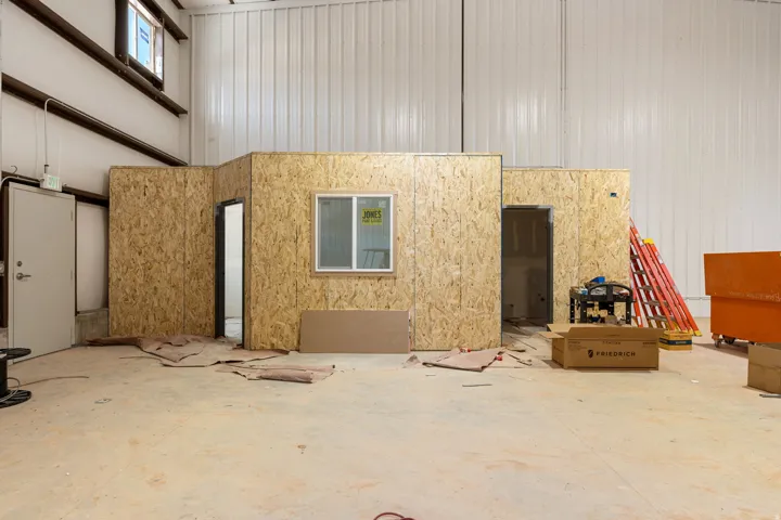 Spacious industrial interior featuring high ceilings and concrete flooring