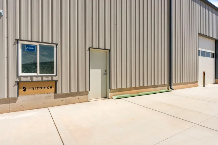 Corrugated metal siding exterior with a concrete foundation