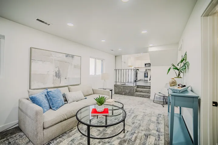 Carpeted living area featuring recessed lighting and a large window