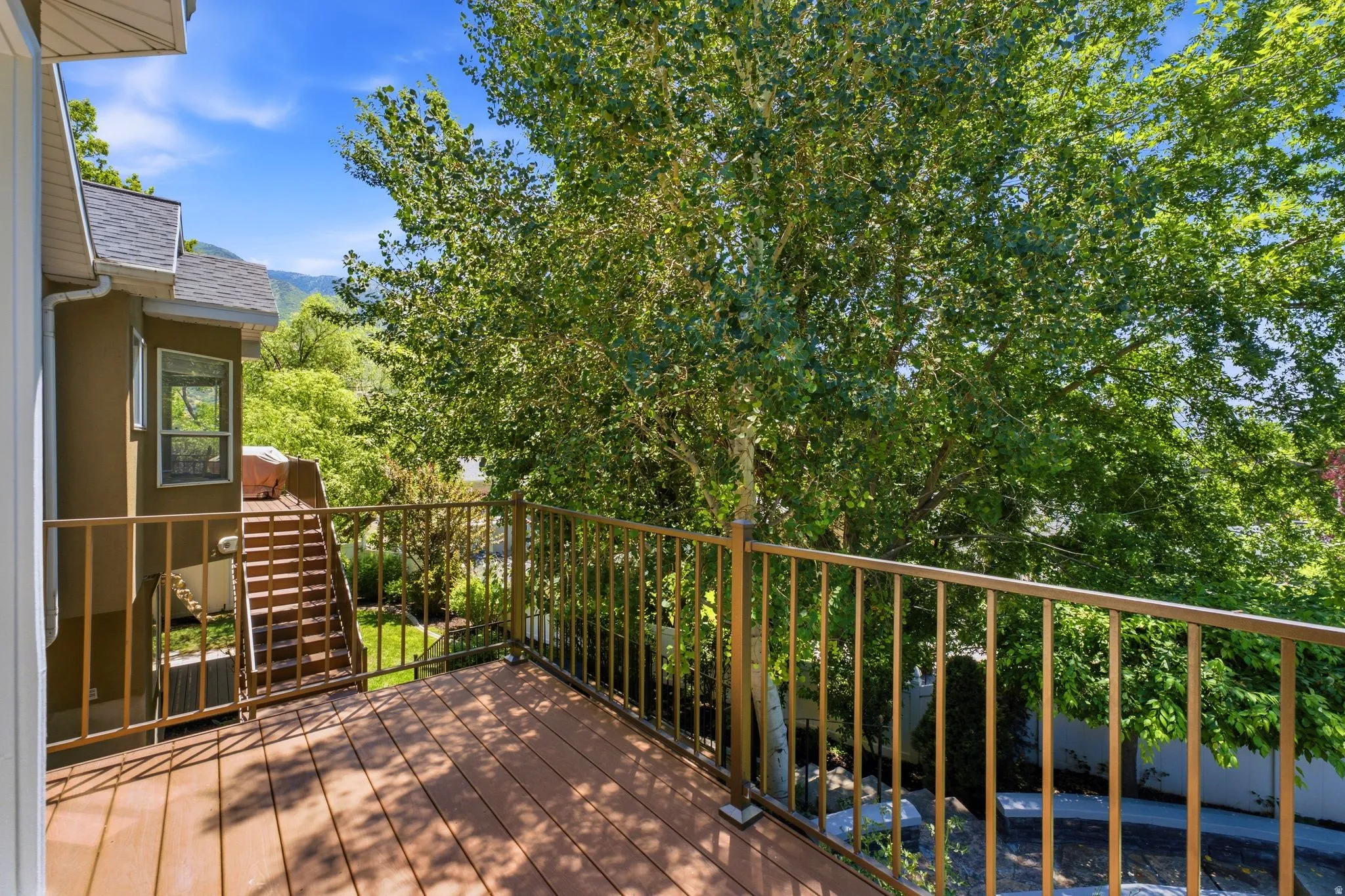 Outdoor decking with composite flooring and metal railings