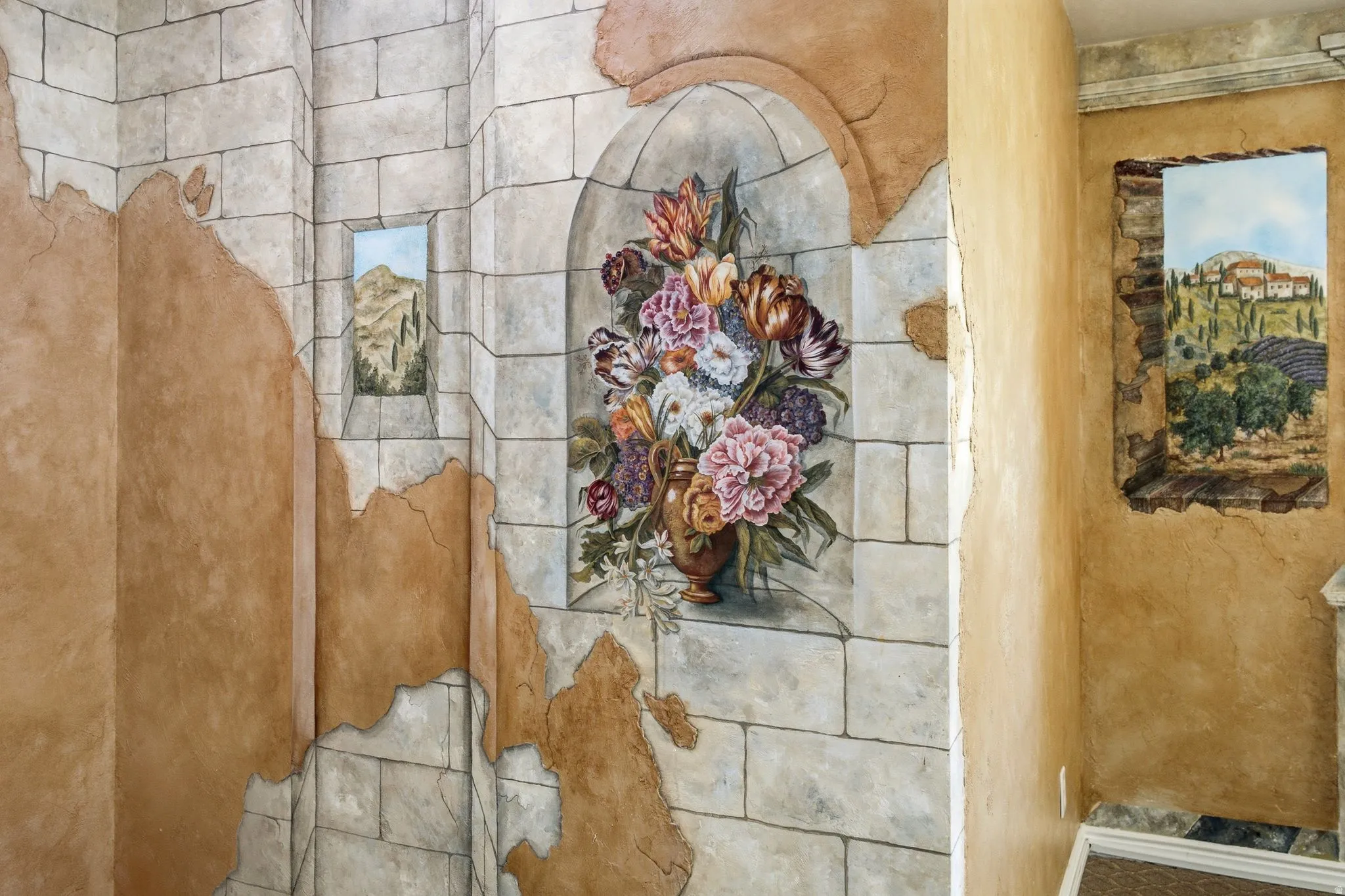 Faux stone block wall with painted floral mural and integrated landscape art