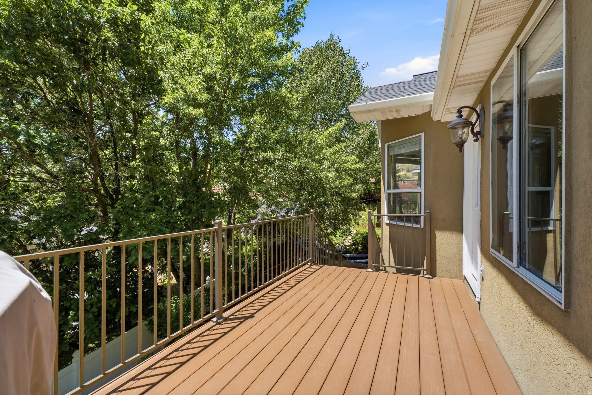 Spacious outdoor deck featuring composite decking and metal railings