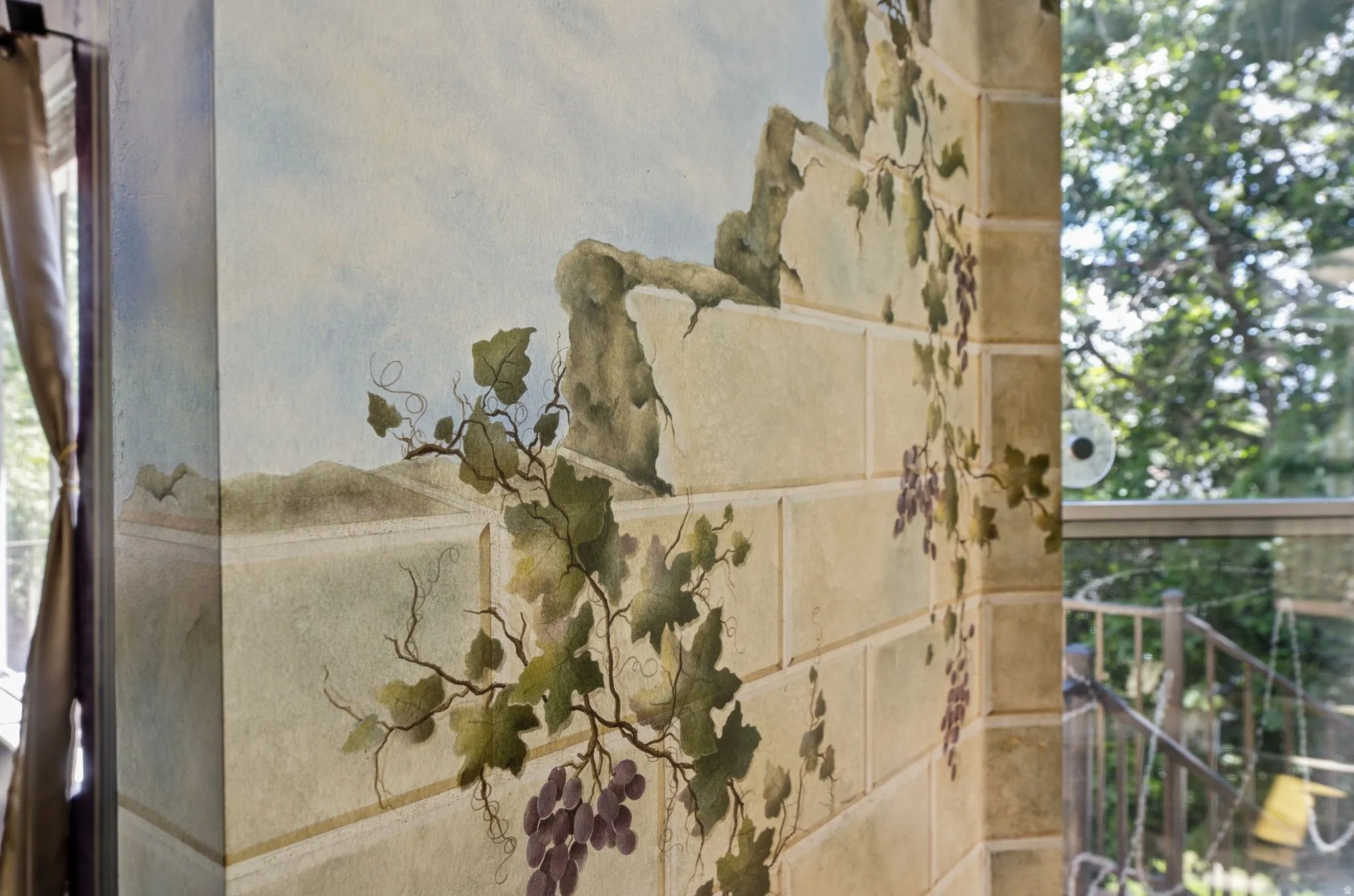 Custom wall mural featuring a classical stonework and grape vine motif