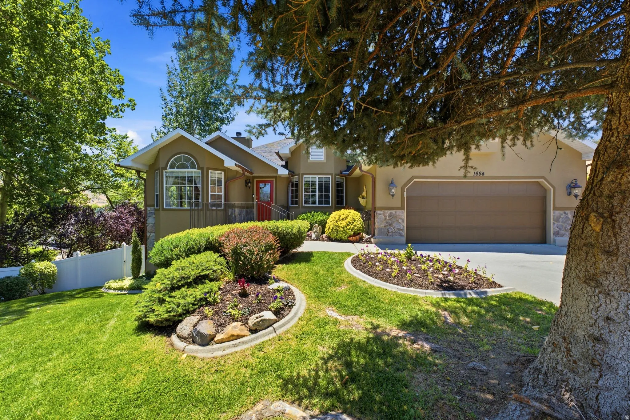 Stucco exterior with stone accents and an attached two-car garage