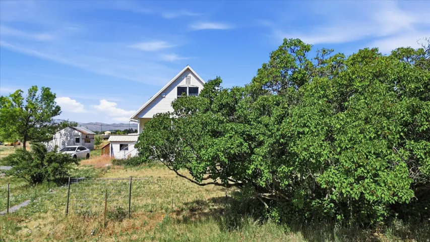 Two-story residence with white siding and a prominent gable roofline