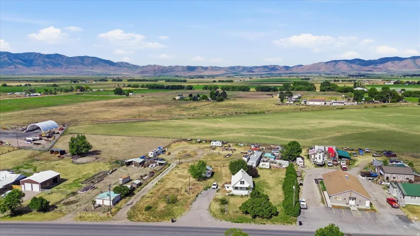 Expansive property featuring a mix of residential structures, commercial buildings, and open land