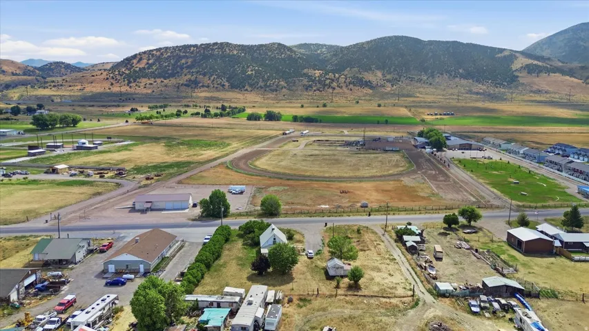 Expansive aerial showcasing a rural landscape with distant mountains
