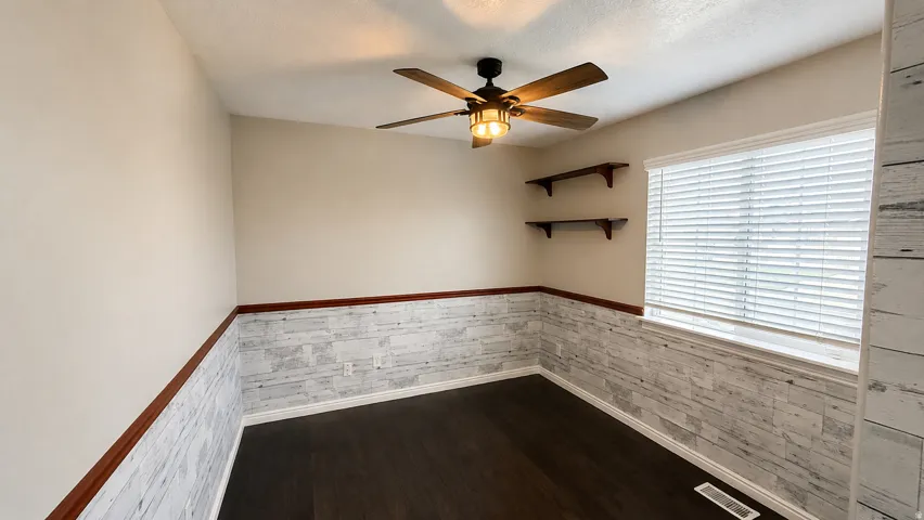 Dark wood-finish flooring with light-toned walls
