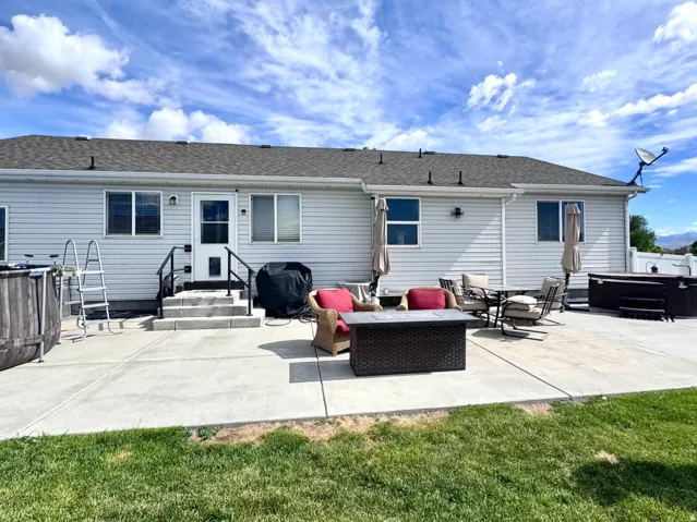 Expansive concrete patio with multiple access points to the home