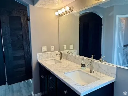 Master Bathroom, Dual vanity with white countertop, undermount sinks, and dark cabinetry