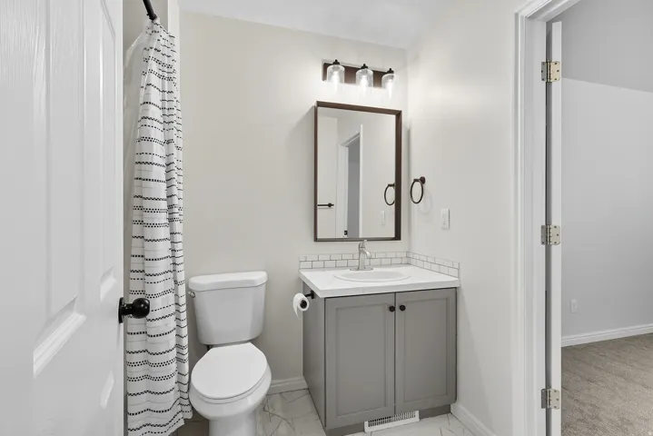 bathroom has door into one bedroom and door into the hallway