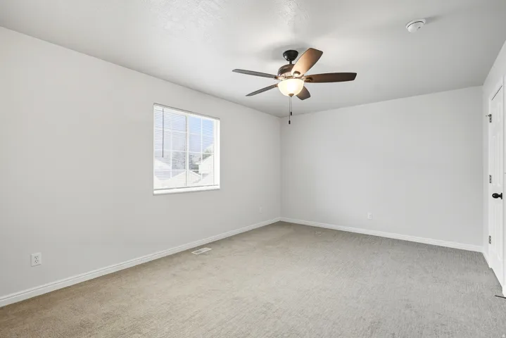 bedroom with door to shared full bathroom