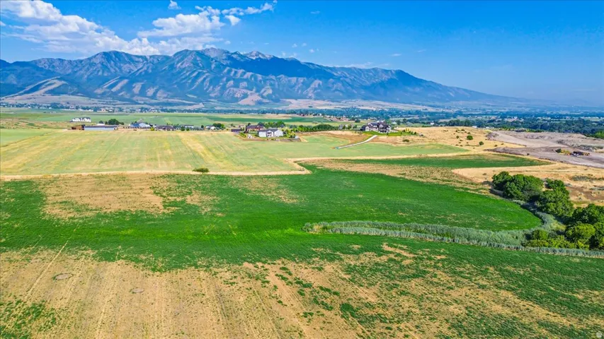 Expansive land parcel featuring open fields and distant mountain ranges