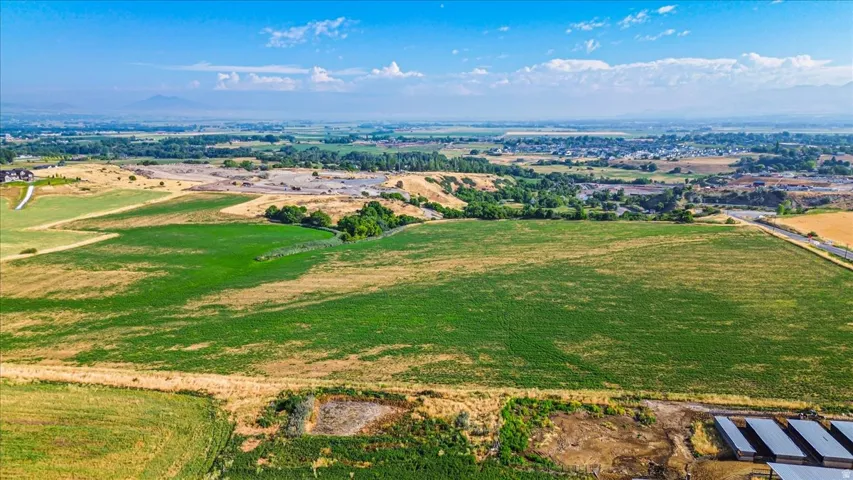 Expansive agricultural land featuring a mix of green and golden fields