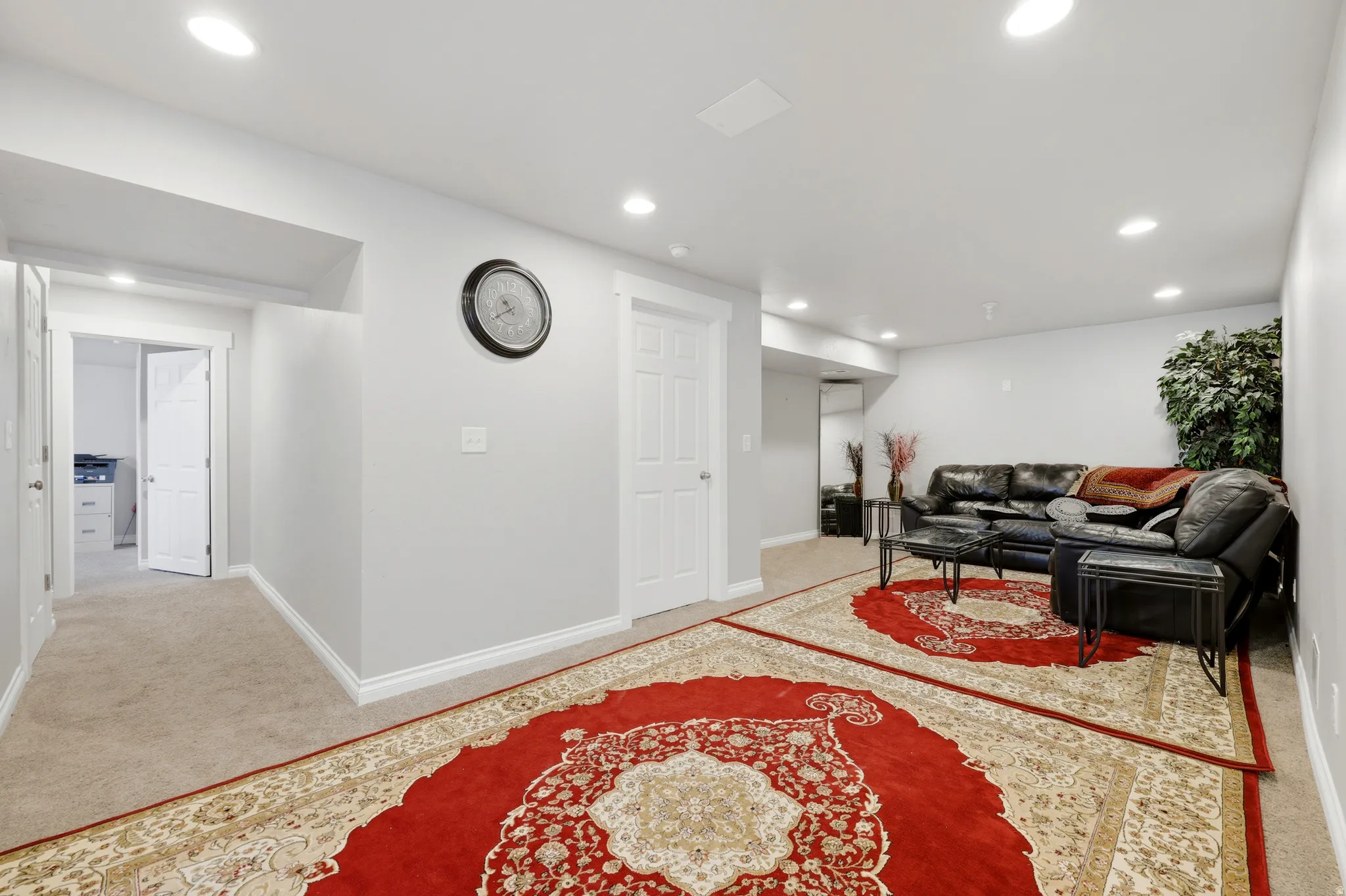 Spacious lower-level area featuring recessed lighting, light gray walls, and white trim