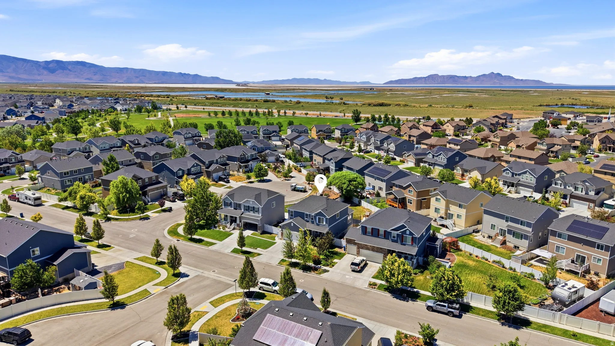Aerial perspective of a residential community with varied home styles adjacent to the park.