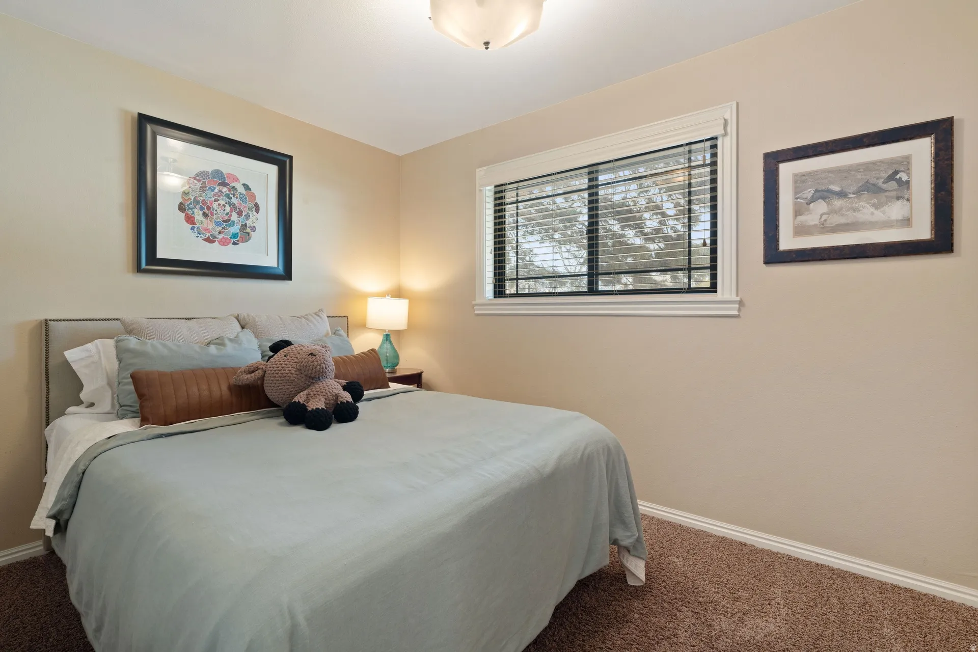 Neutral tone walls, recessed window with white trim, dark window blinds, and brown carpet flooring
