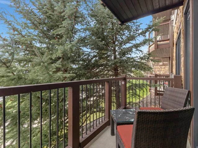 Private balcony with dark wood railing and slatted posts