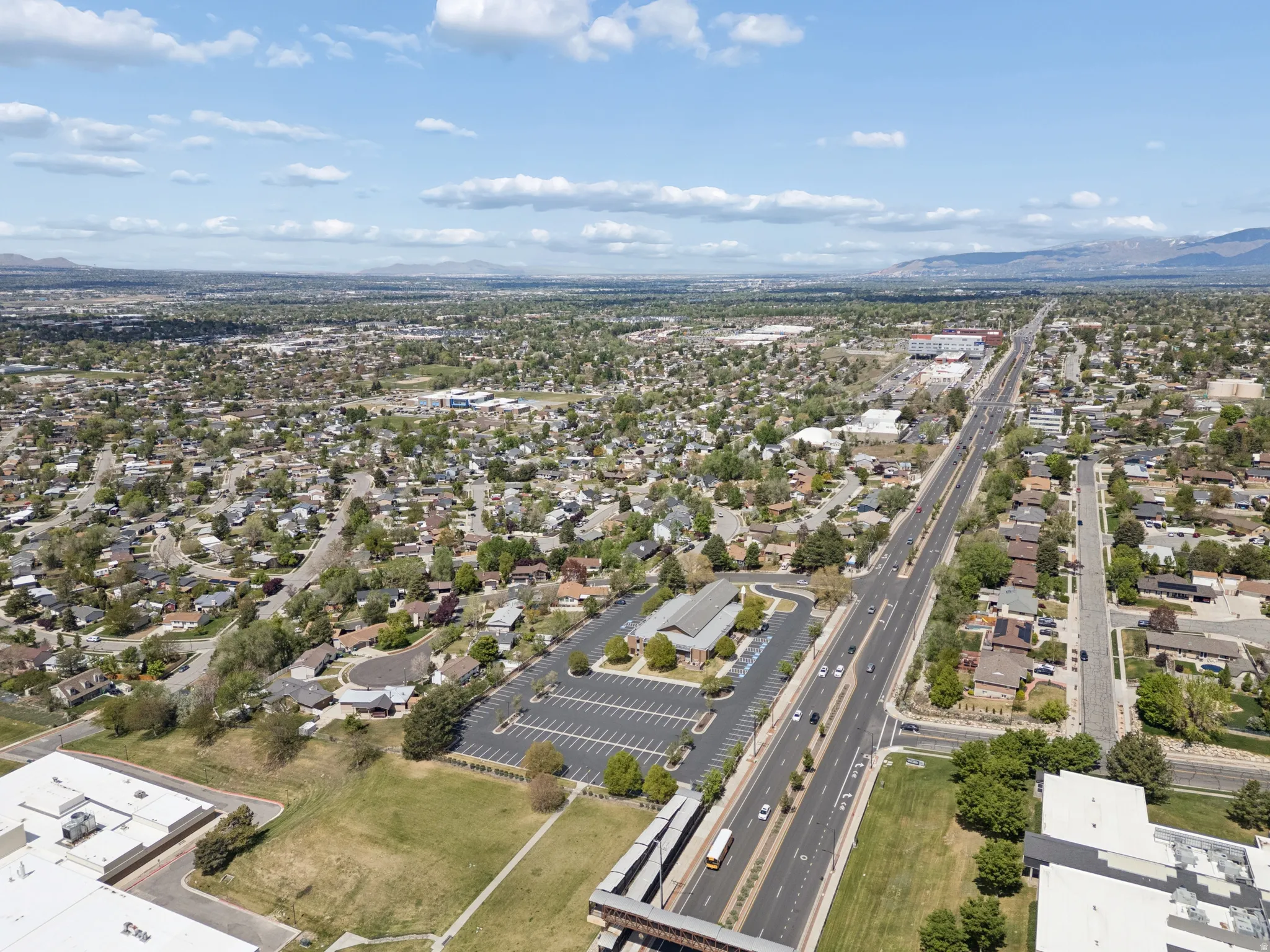 Aerial perspective showcasing an expansive urban landscape with residential and commercial areas