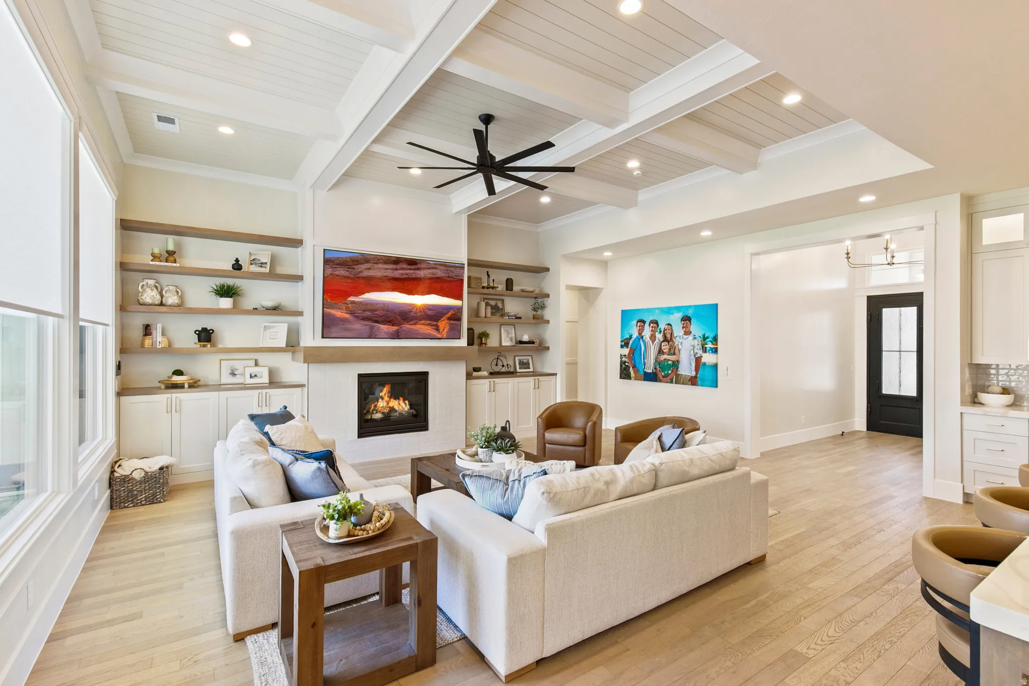 Coffered ceiling with recessed lighting and a black ceiling fan