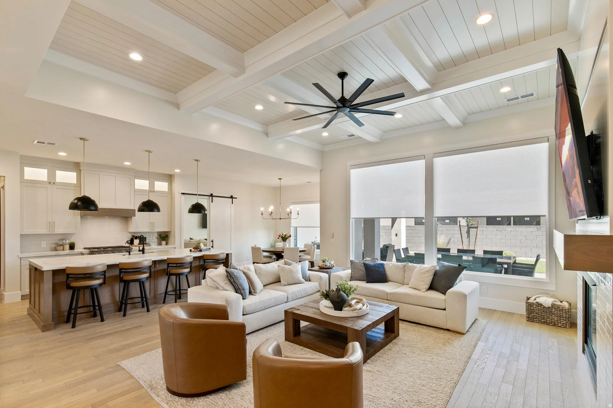 Vaulted coffered ceiling with wood-finish planks and recessed lighting
