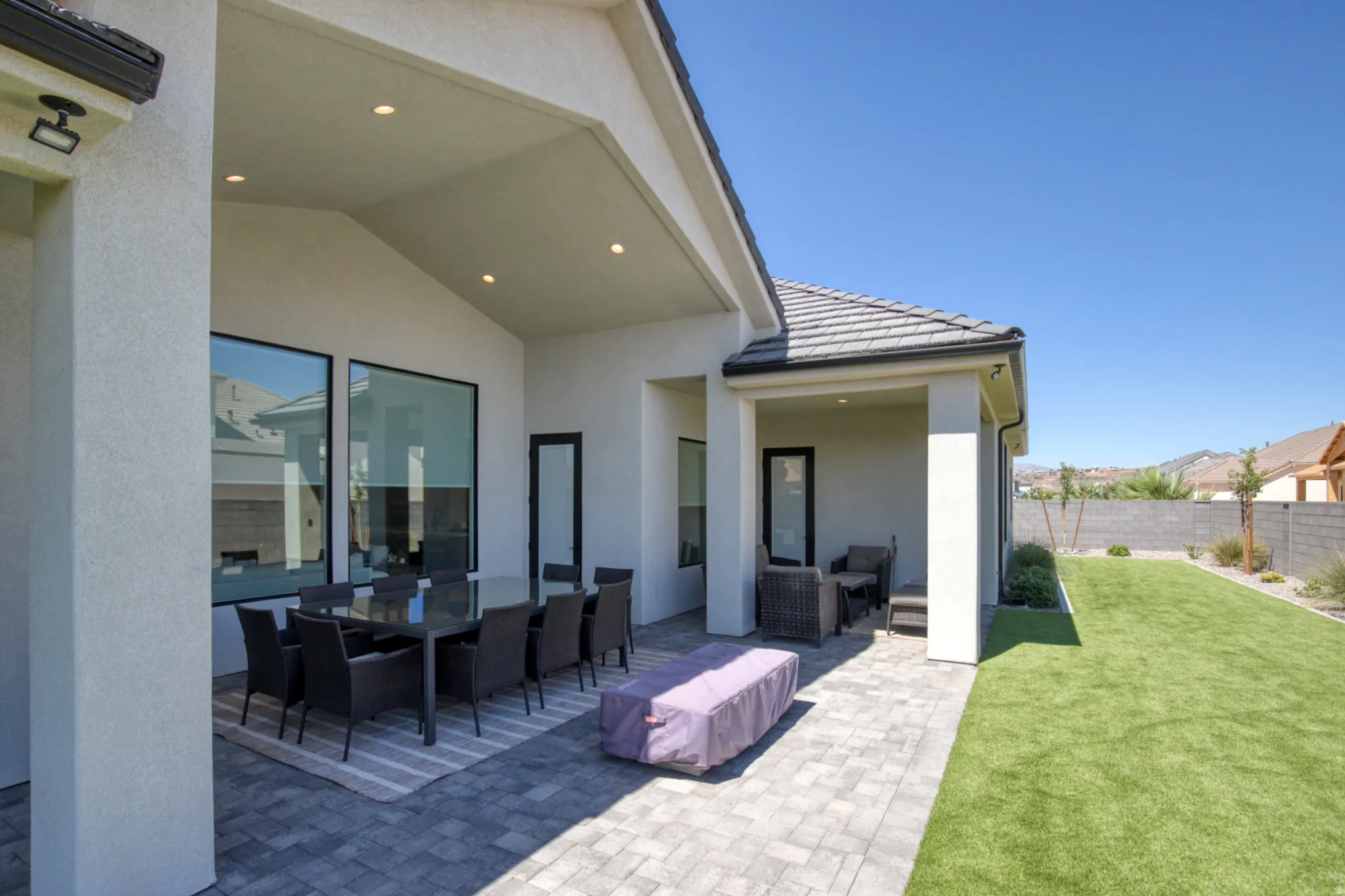 Covered patio featuring recessed lighting, a paver stone surface, and a vaulted ceiling