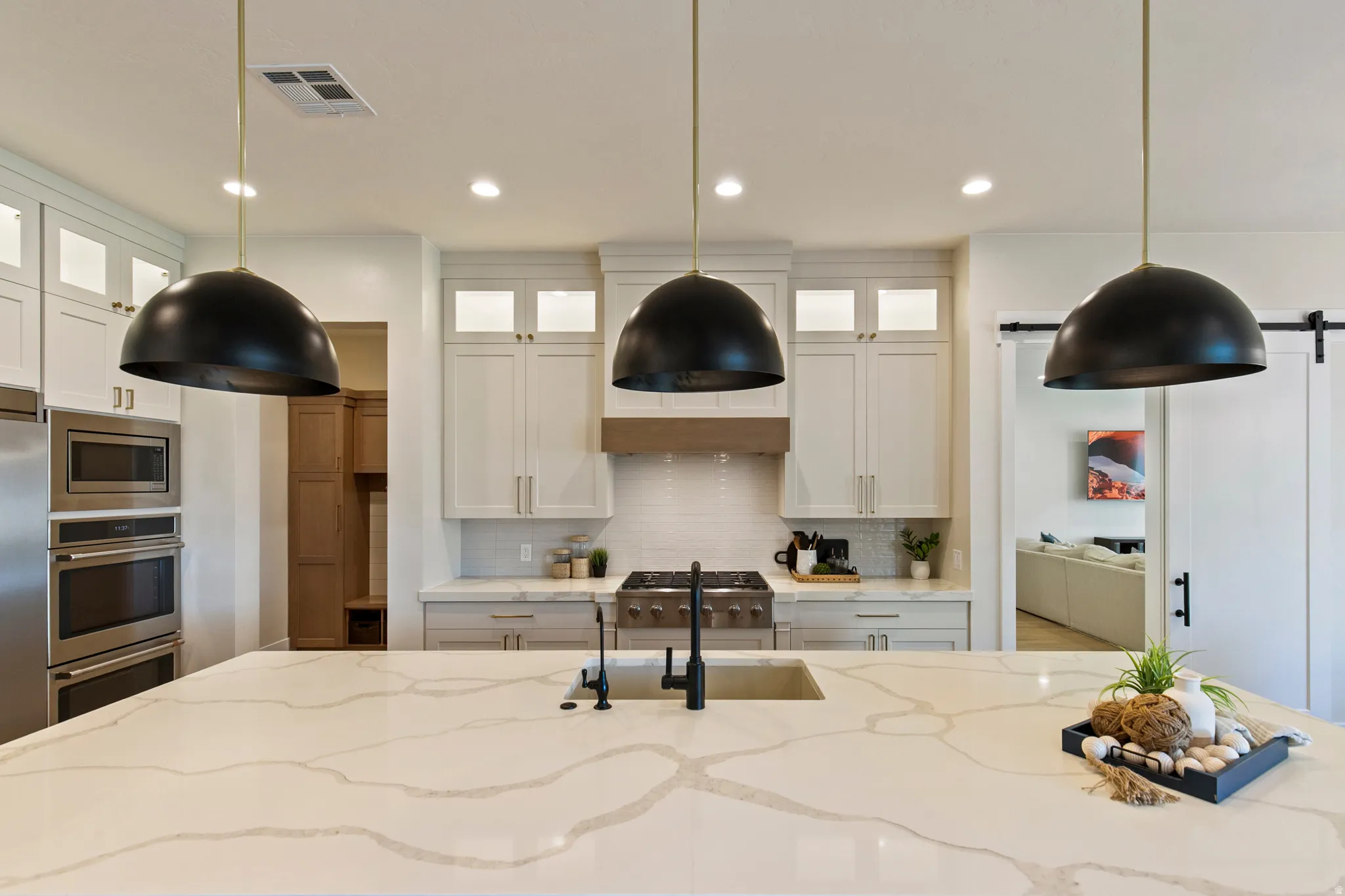 Spacious kitchen island with a light-toned countertop featuring prominent veining
