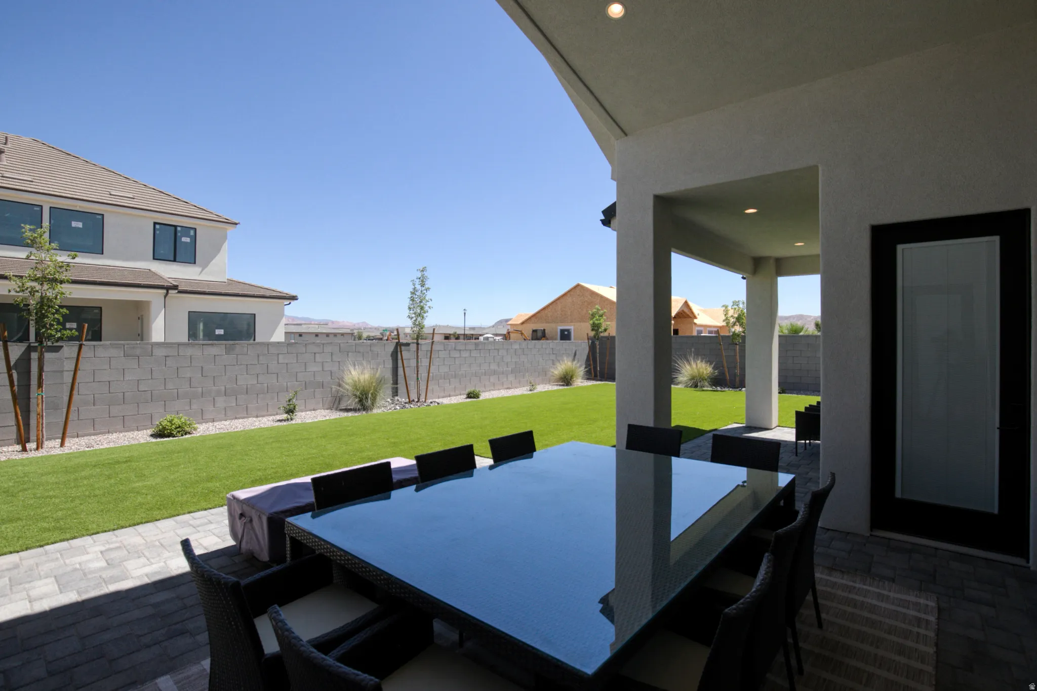 Expansive covered patio with recessed lighting and paver flooring