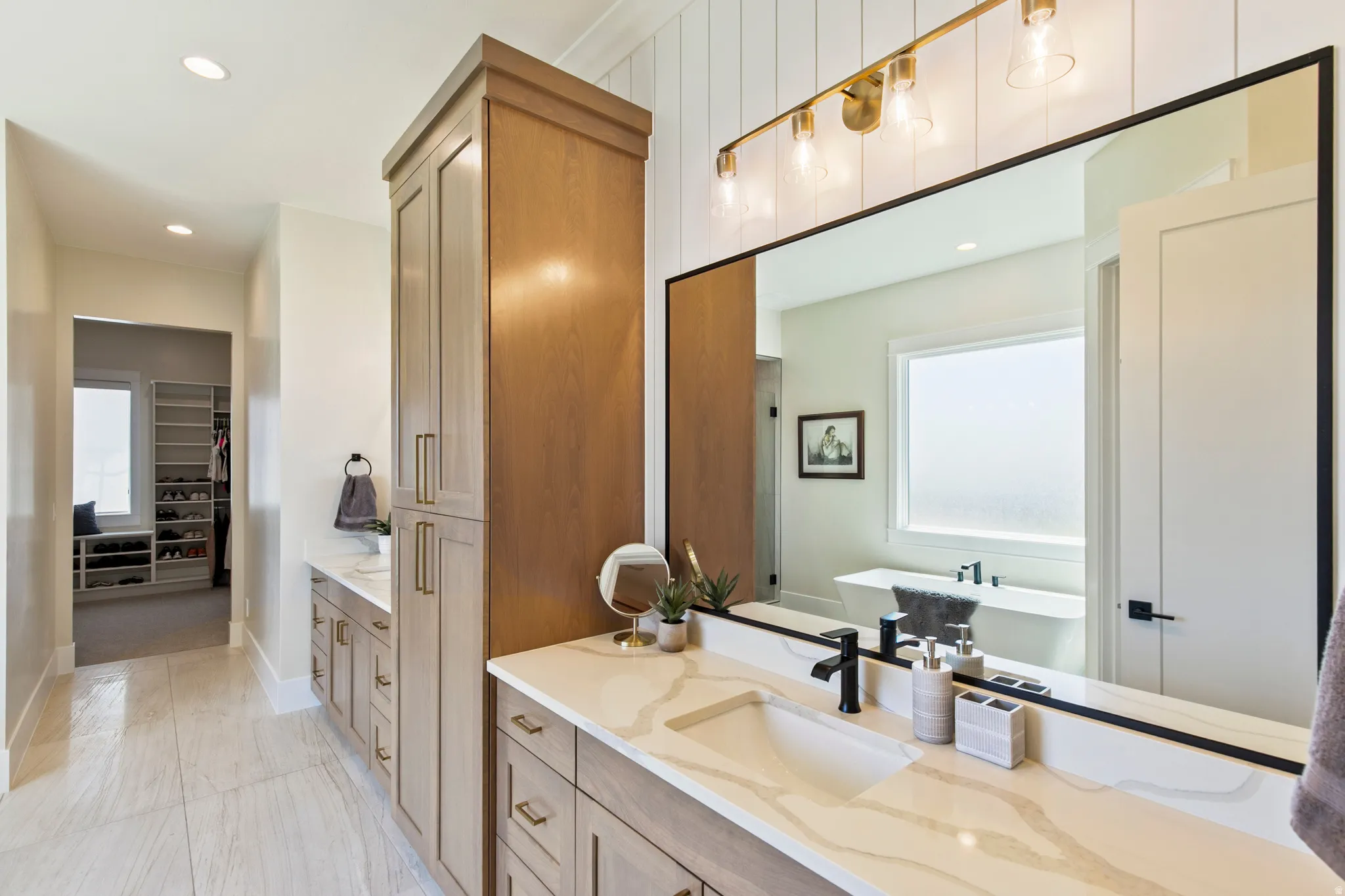 Dual vanity with quartz countertops, integrated sinks, and matte black fixtures