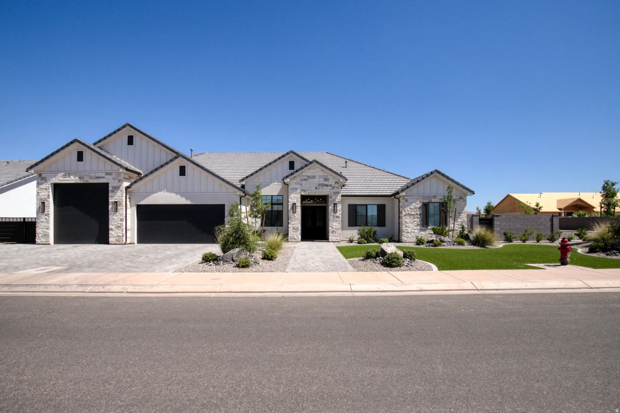 Contemporary exterior featuring stone veneer and vertical white siding