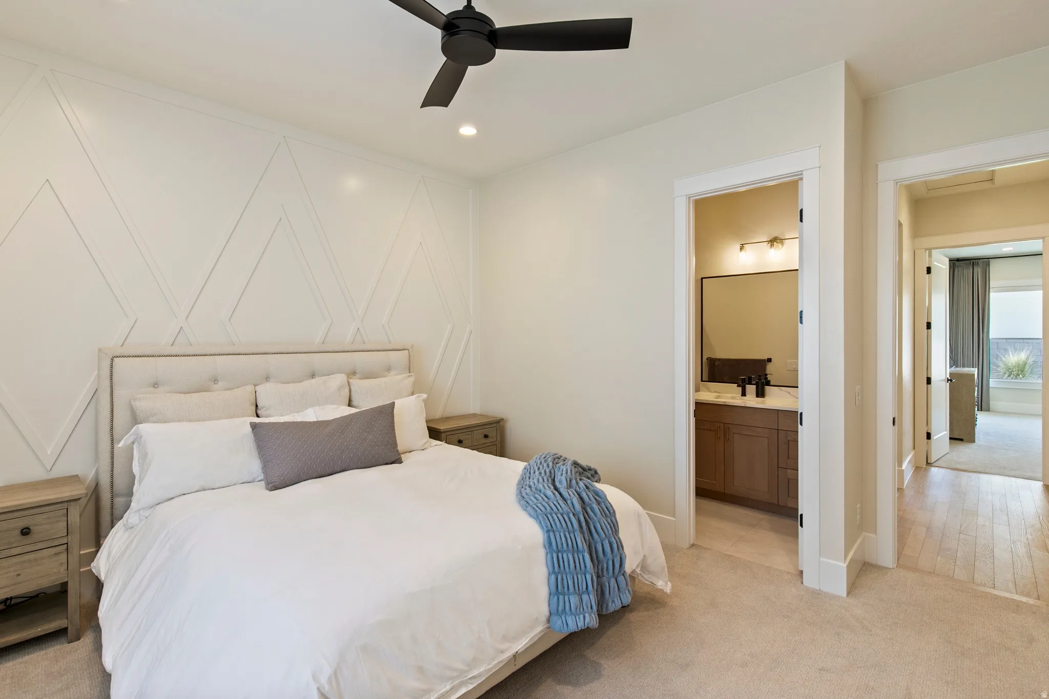 Bedroom featuring a decorative accent wall, recessed lighting, and a ceiling fan