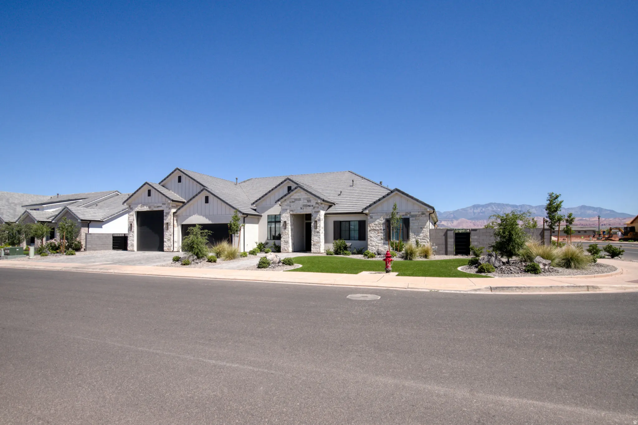 Contemporary exterior with prominent gables and a light gray shingle roof
