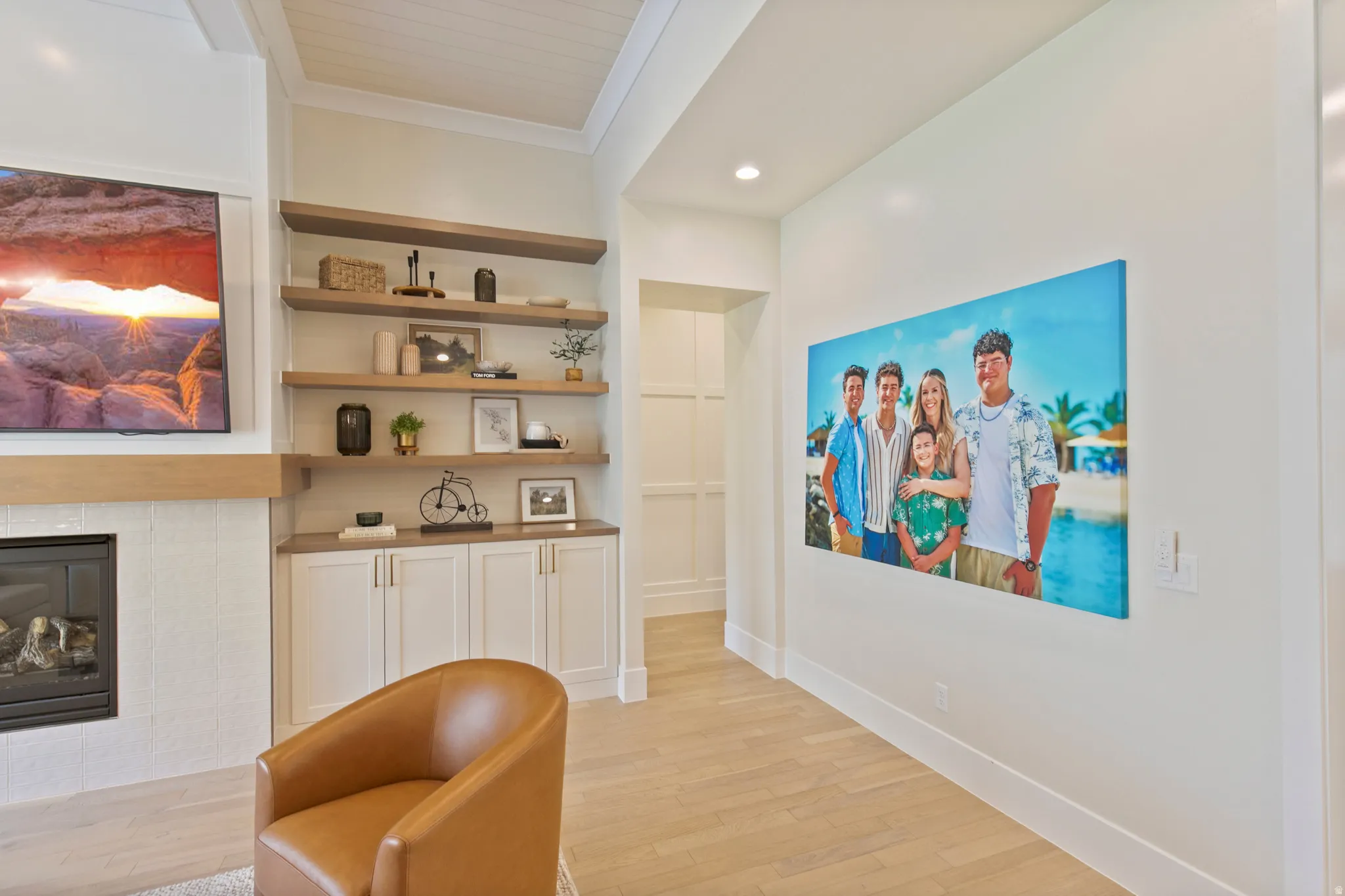 Built-in shelving with wood-finish tops, white cabinetry, and light wood-finish flooring