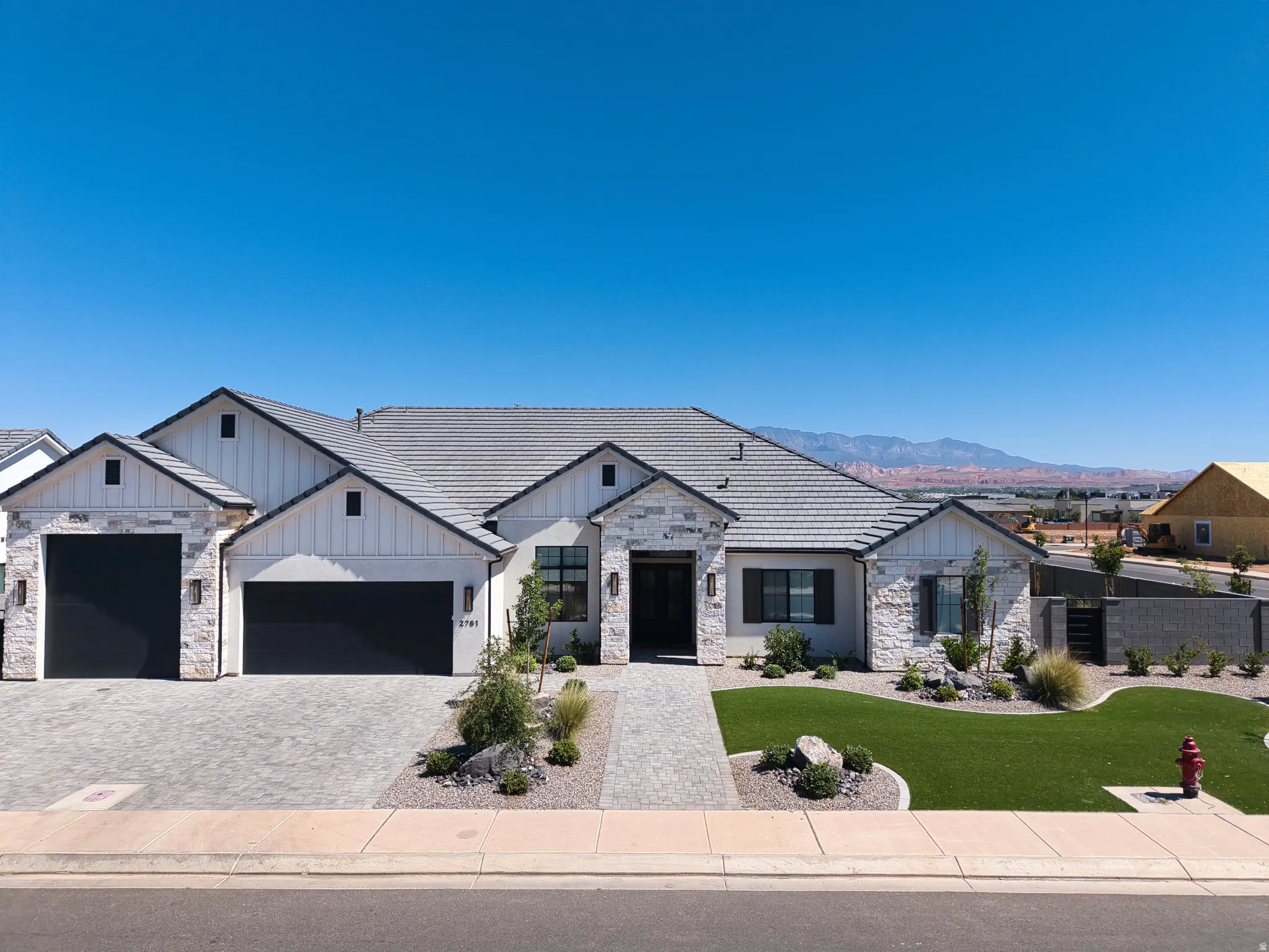 Modern single-story residence with a stone and board-and-batten facade