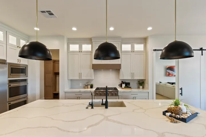 Spacious kitchen island with a light-toned countertop featuring prominent veining