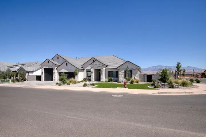Contemporary exterior with prominent gables and a light gray shingle roof