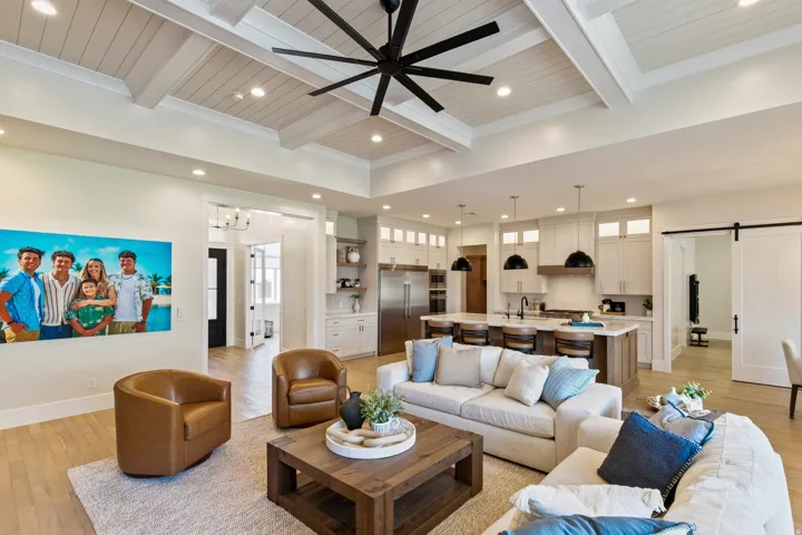 Open-concept interior featuring a coffered ceiling with a ceiling fan, light wood-finish flooring, and recessed lighting